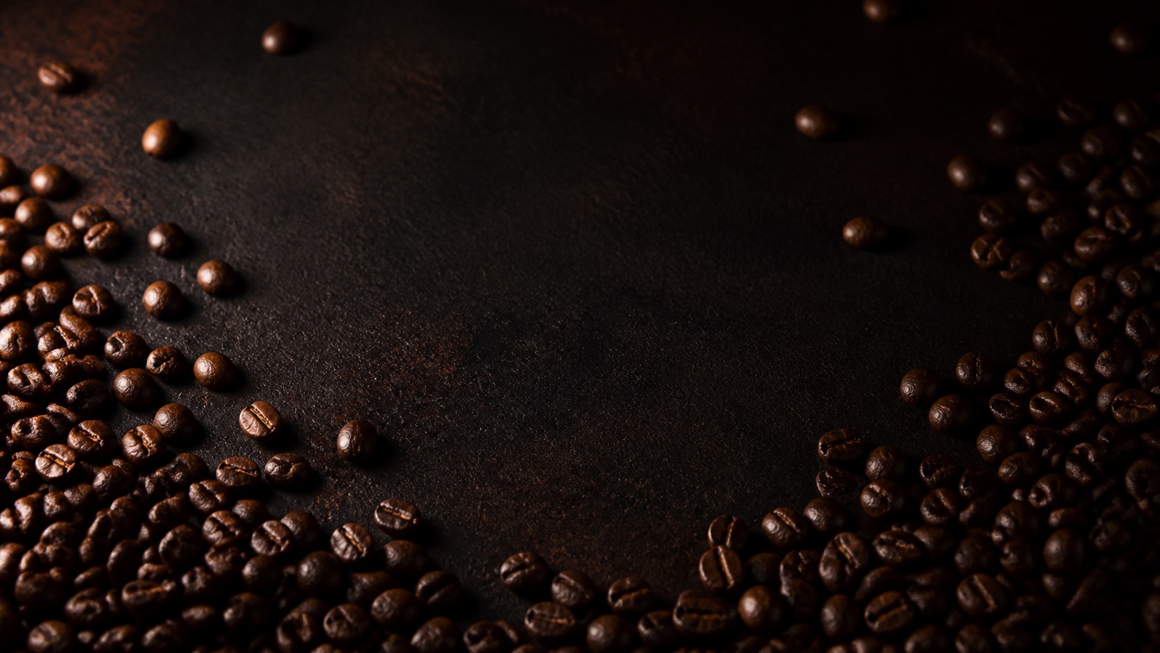 Roasted coffee beans on a dark surface